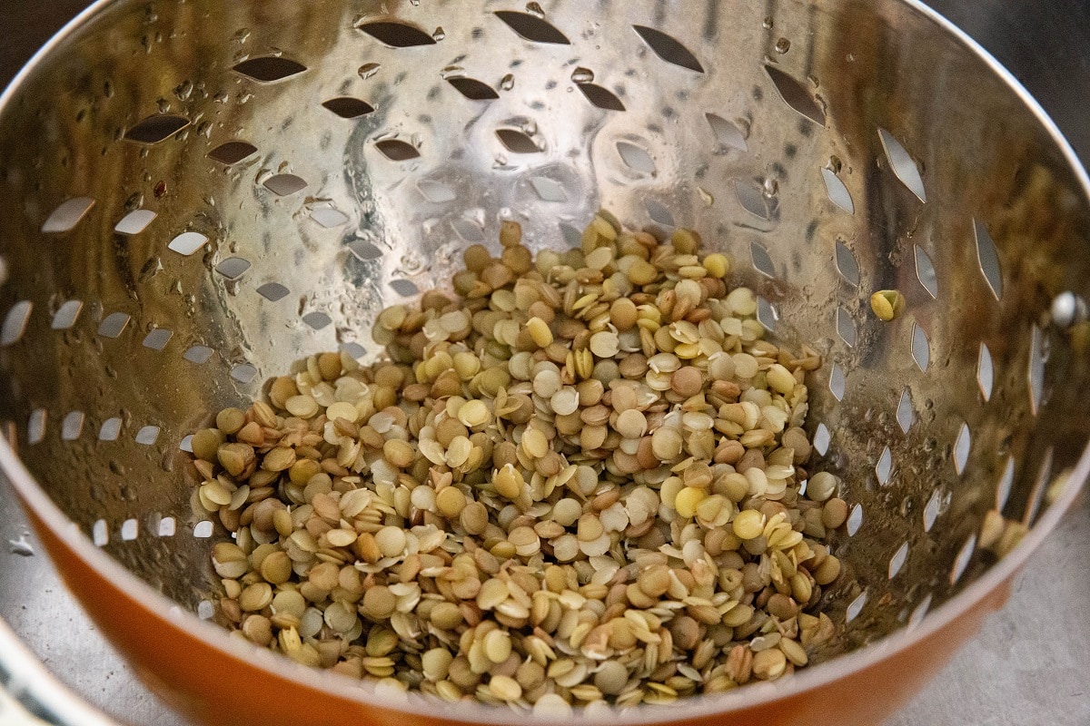 Cooked lentils in a collander.