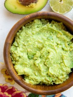Wooden bowl of the best guacamole recipe ever.