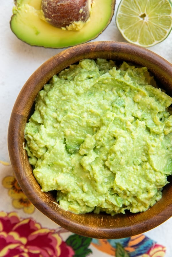 Wooden bowl of the best guacamole recipe ever.