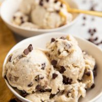 Two white bowls of cookie dough ice cream.