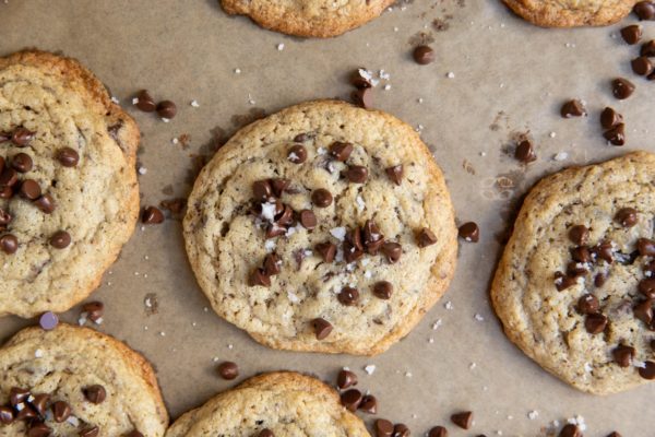 Freshly baked oat flour cookies on a baking sheet.