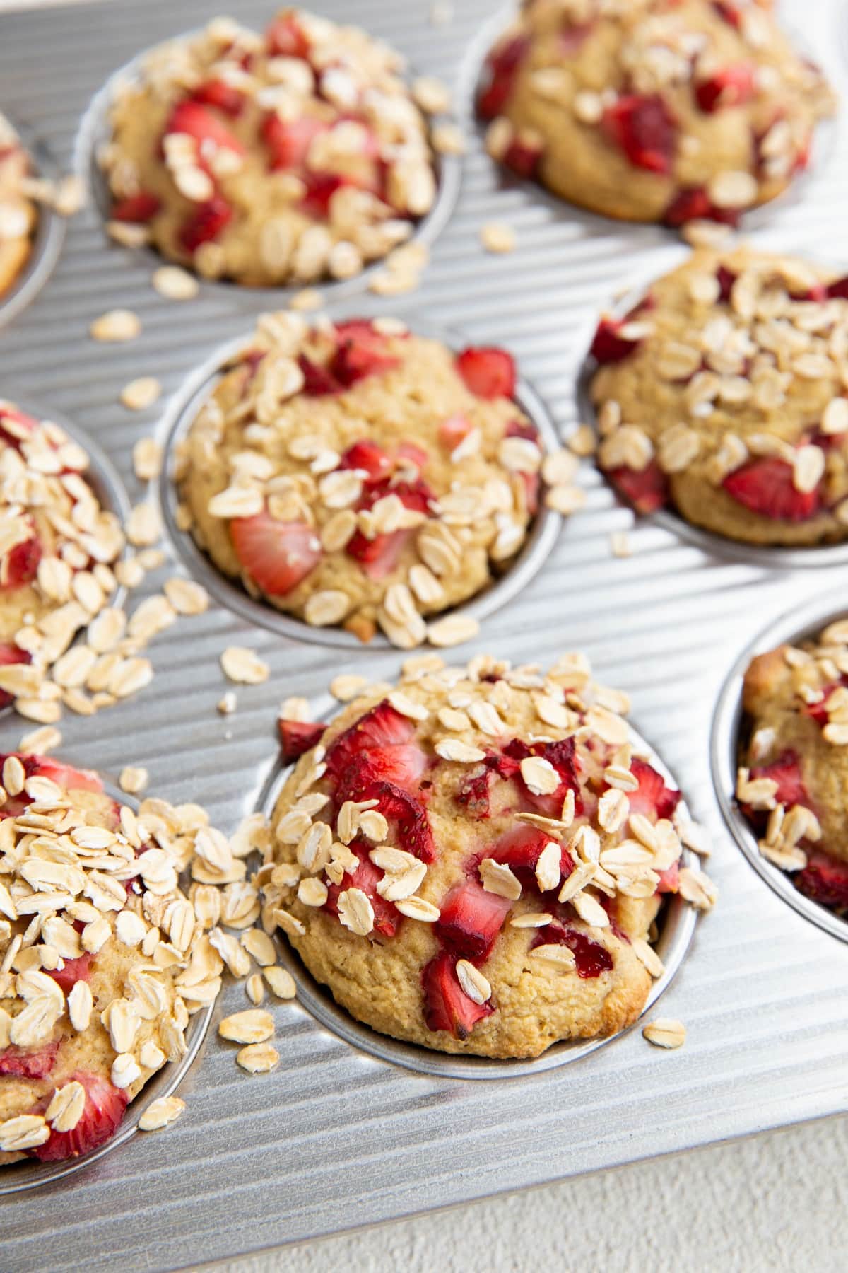 Strawberry oatmeal muffins in a muffin tin, fresh out of the oven.