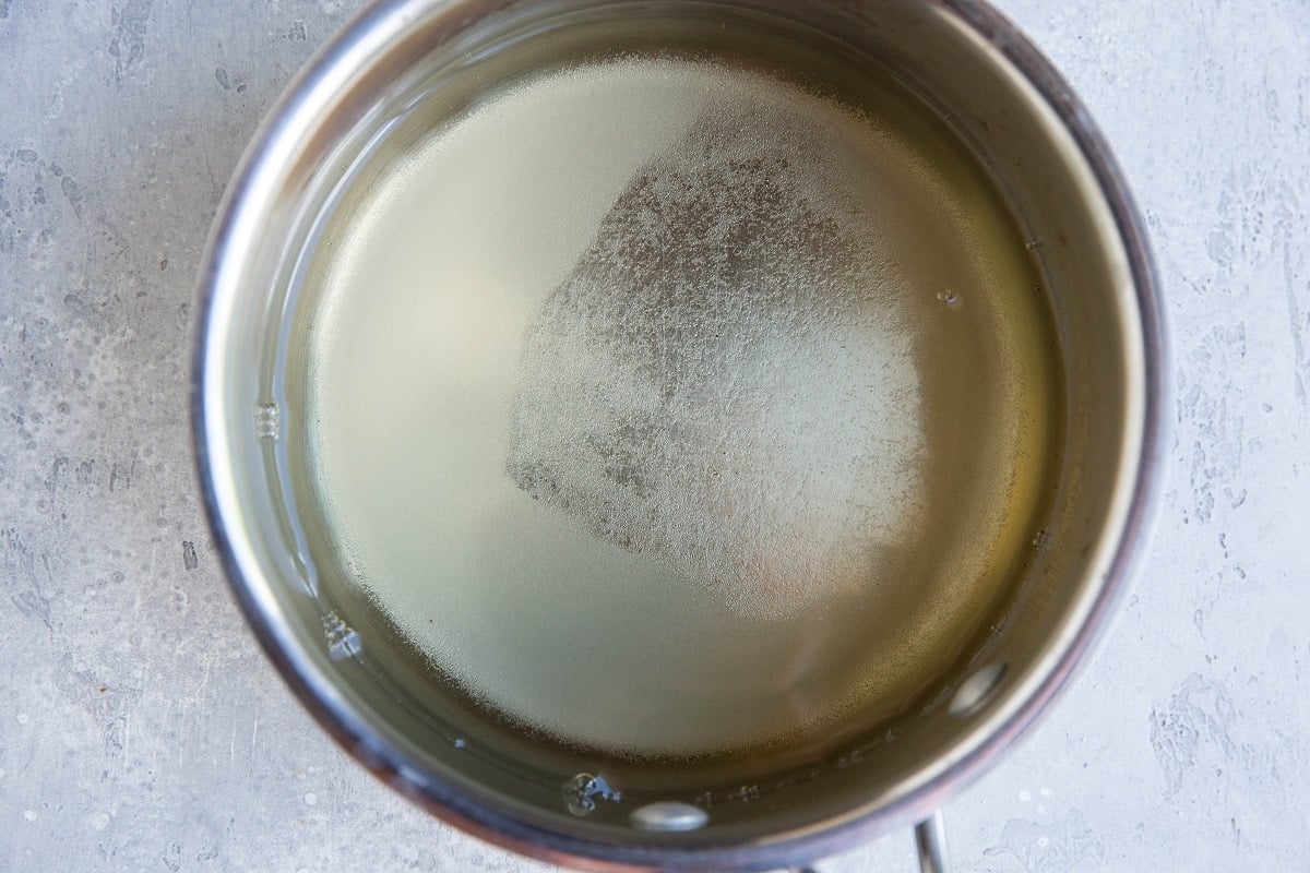 Brining liquid in a saucepan to be heated up. Vinegar, water, and sugar.