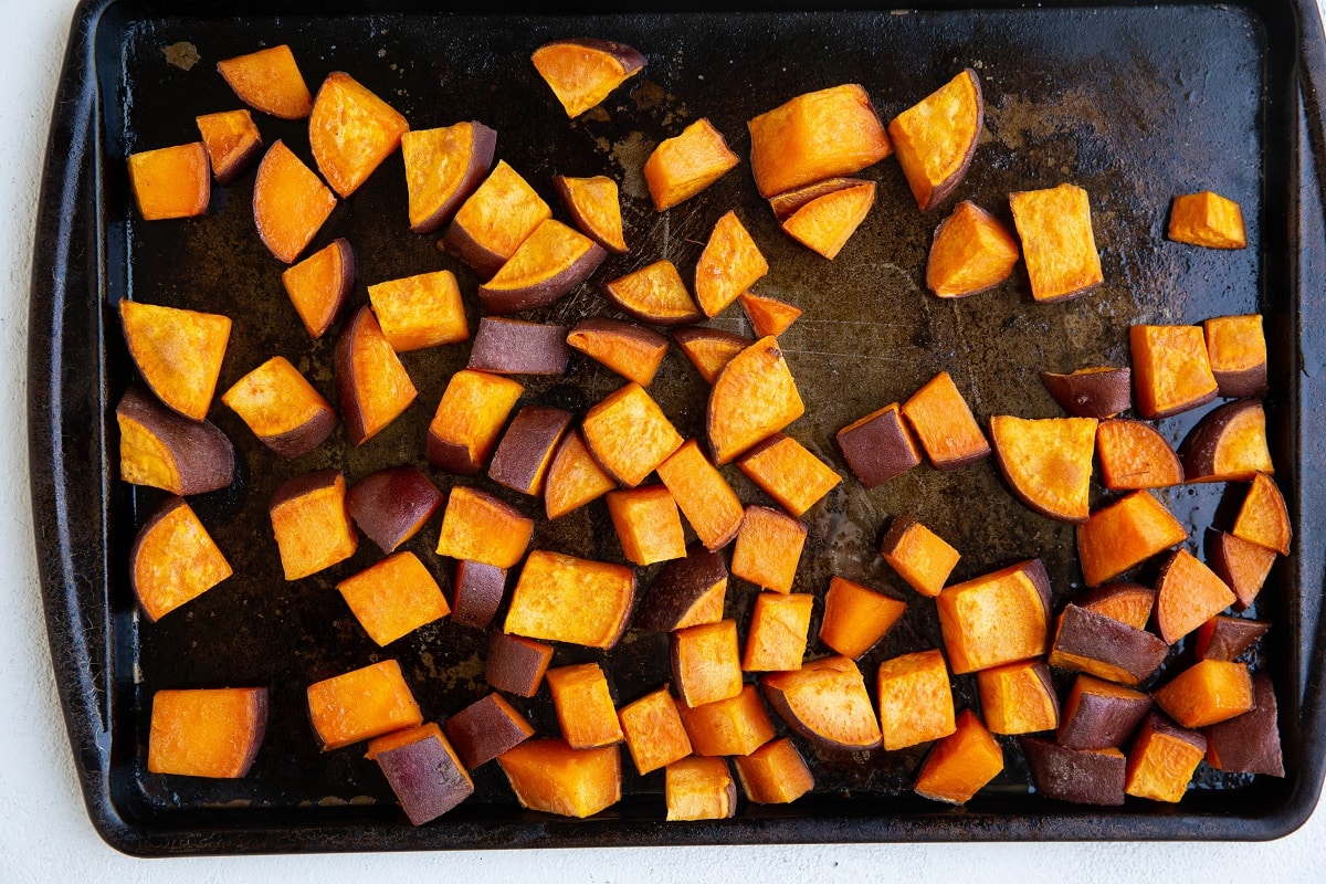 Roasted sweet potatoes on a baking sheet.