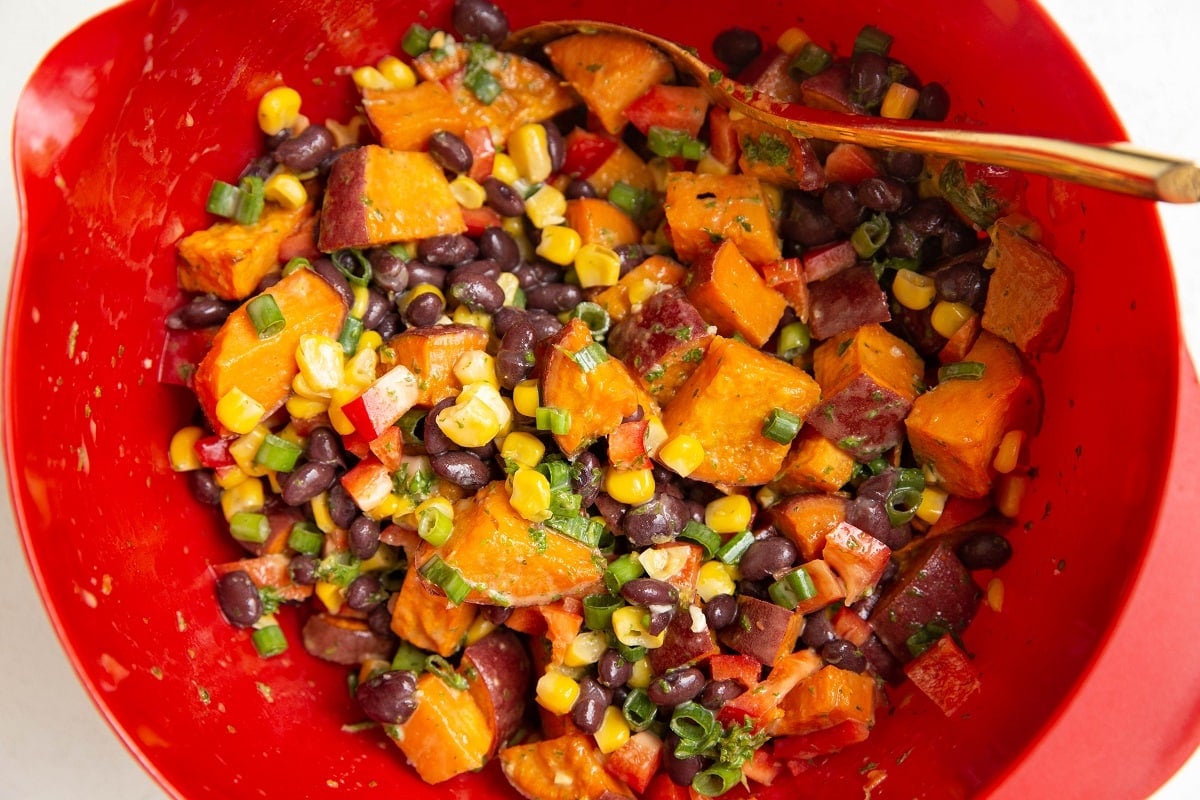 Sweet potato salad mixed up in a large mixing bowl.