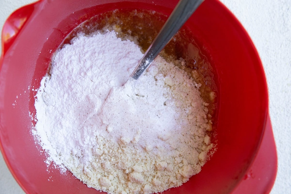almond flour and tapioca flour on top of the wet ingredients, ready to be mixed in.