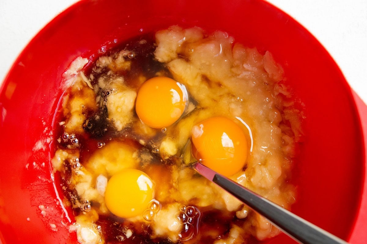 Eggs, pure maple syrup, overripe bananas in a mixing bowl.