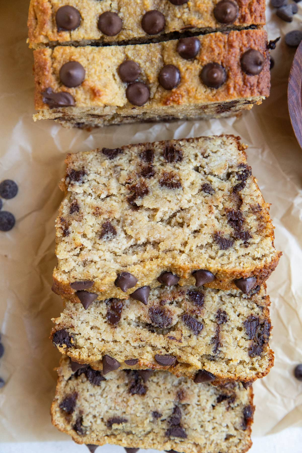 Banana bread sliced on a sheet of parchment paper.