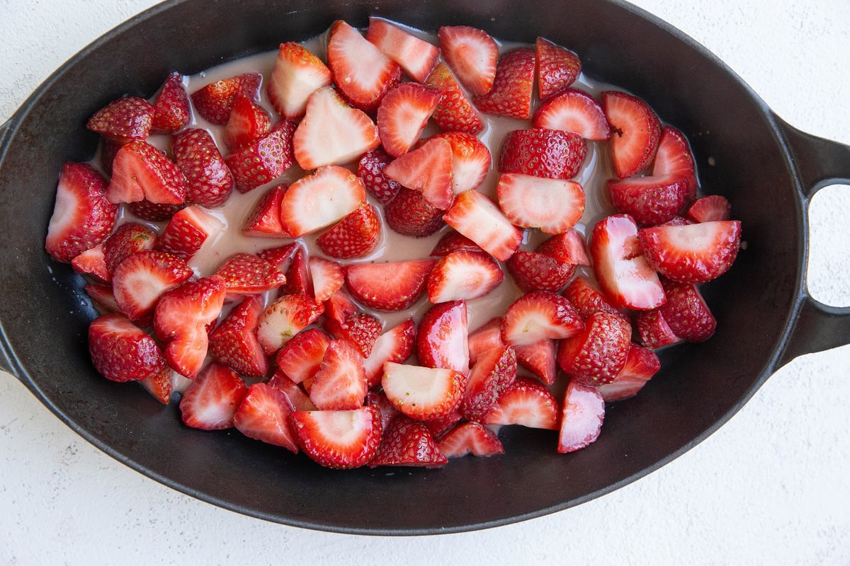 Strawberry filling ingredients in the bottom of a baking dish.