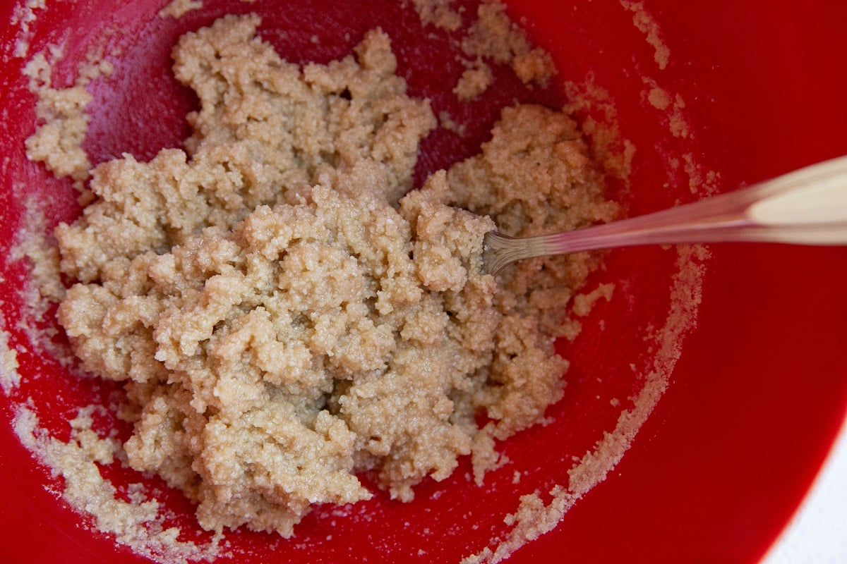 Almond flour crumble topping in a red mixing bowl.