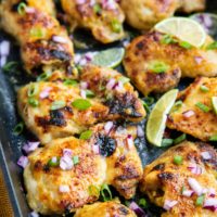 Mojo chicken thighs fresh out of the oven in a large baking dish.