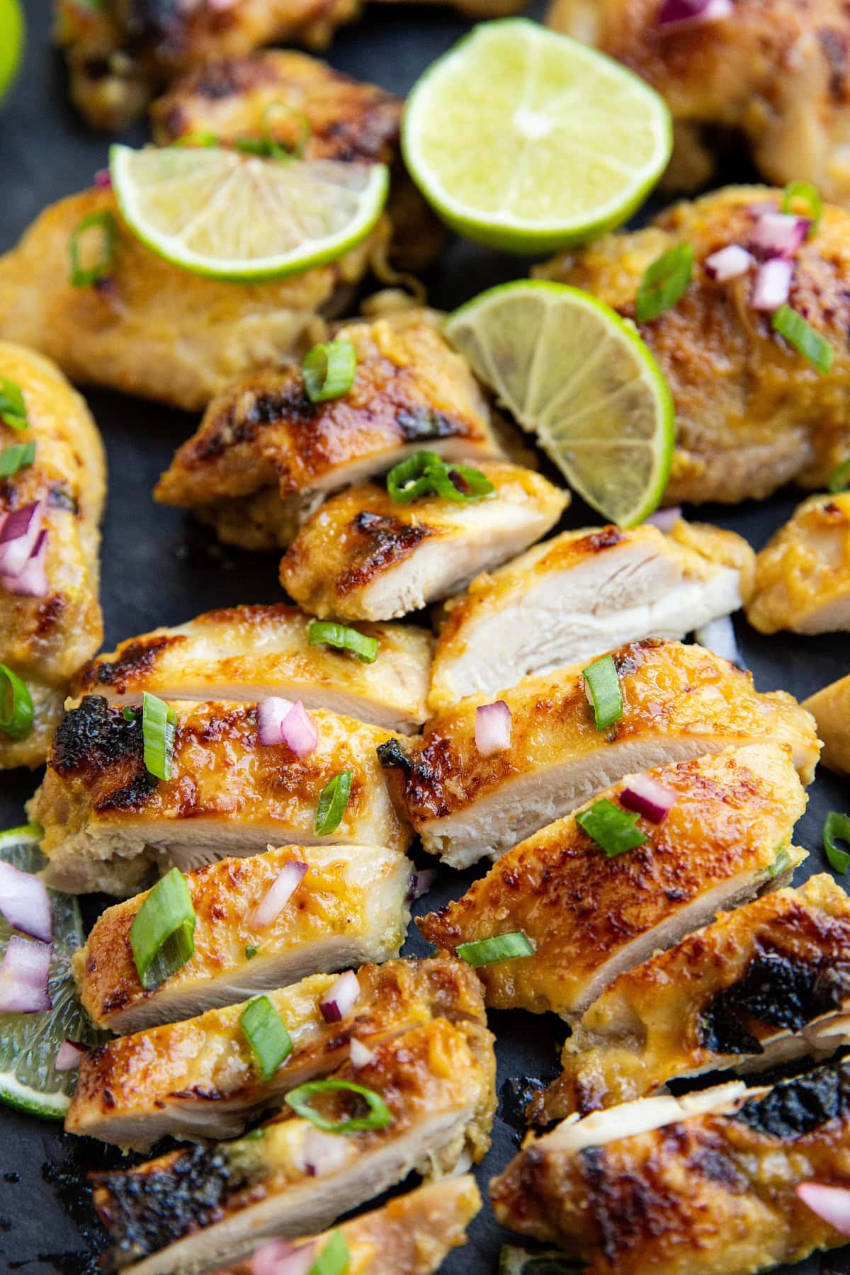 Sliced chicken thighs on a cutting board.