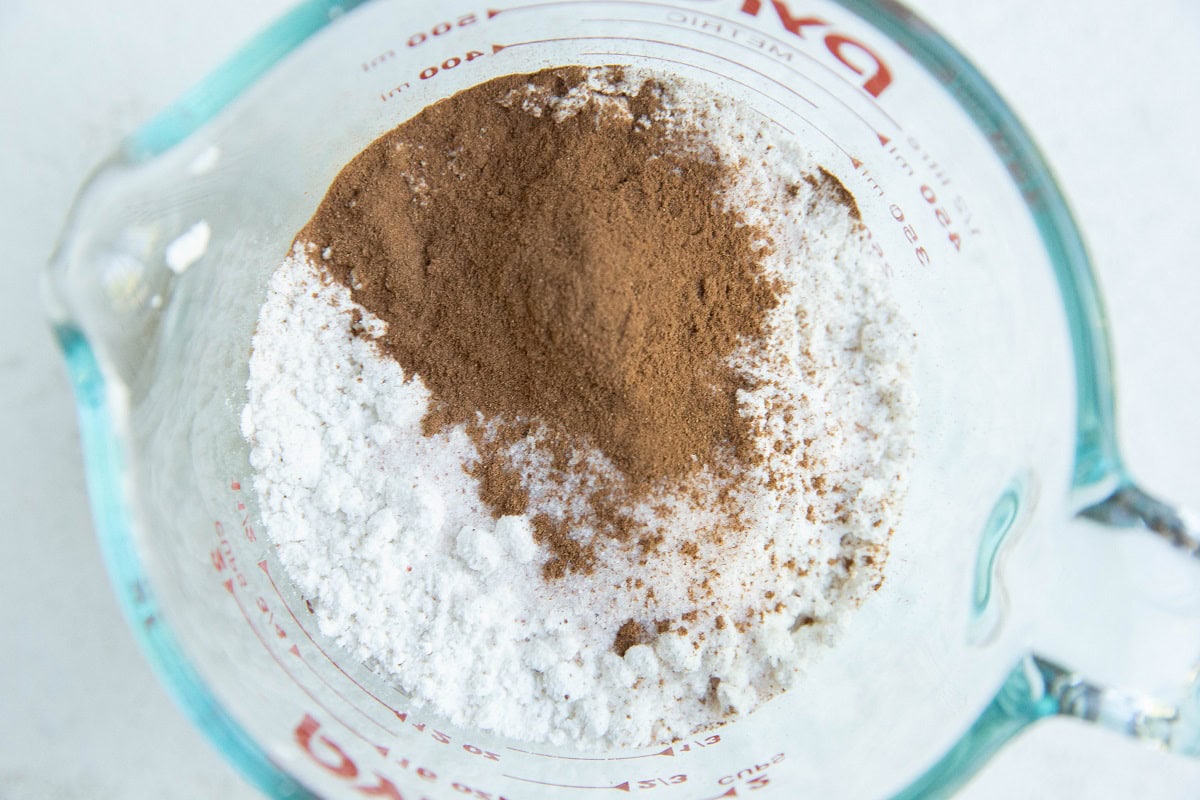 Dry ingredients for zucchini bread in a measuring cup.