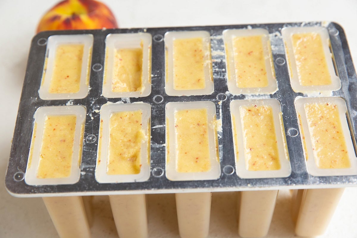 Popsicle mold filled with peach popsicle mold.