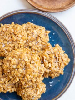 Blue plate with peanut butter oatmeal cookies stacked on it, ready to eat.