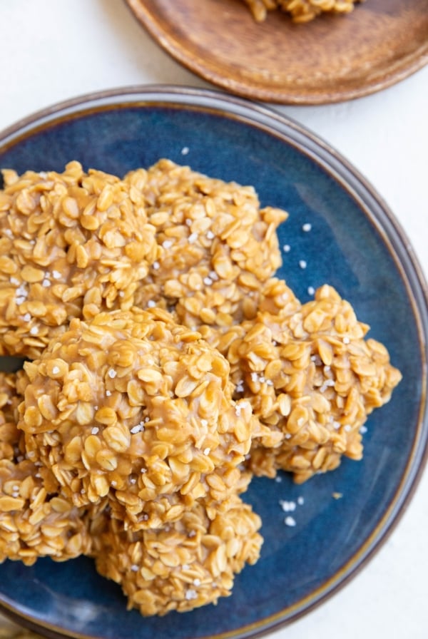 Blue plate with peanut butter oatmeal cookies stacked on it, ready to eat.
