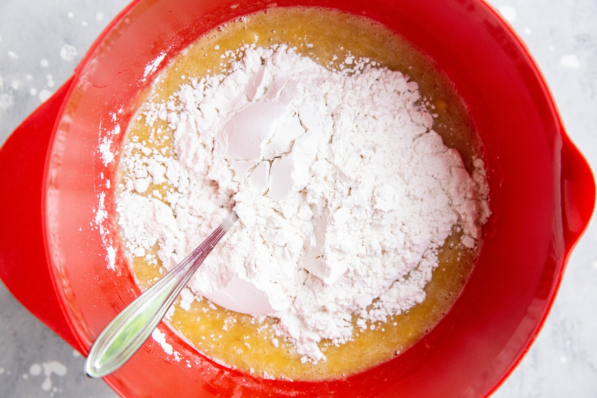 Dry ingredients on top of wet ingredients in a mixing bowl.