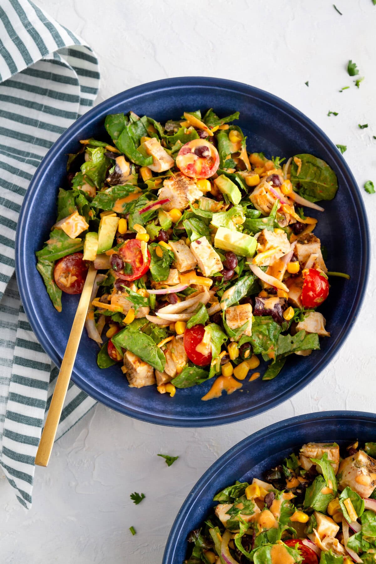 Two blue bowls of Southwest Chicken Chopped Salad, ready to eat.