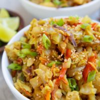 Two white bowls full of Thai cabbage and chicken.