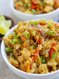 Two white bowls full of Thai cabbage and chicken.