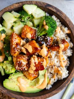 Wooden bowl of salmon bites and veggies.