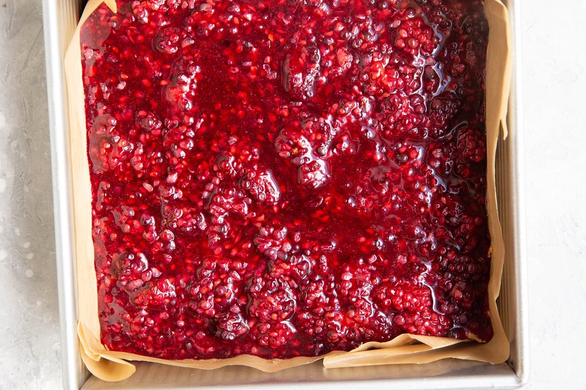 Blackberry filling layer over a crust layer to make blackberry bars.