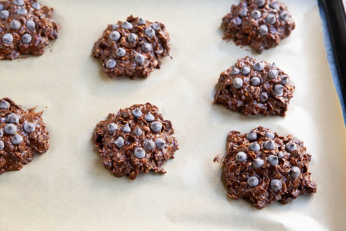 Double chocolate oatmeal cookie dough on a parchment-lined baking sheet.