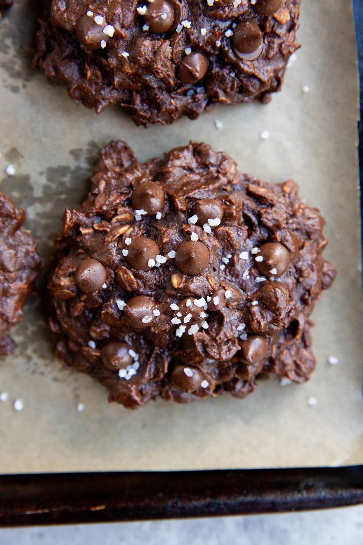Double chocolate oatmeal cookies on a cookie sheet, ready to eat.