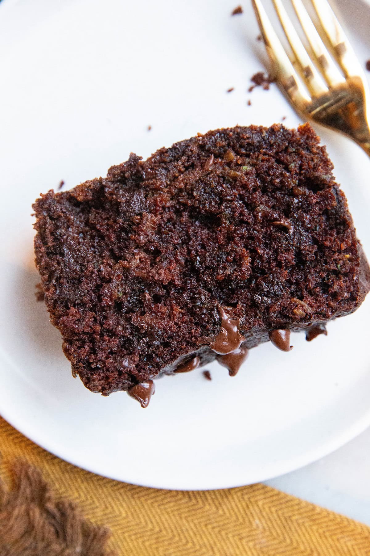 Slice of chocolate zucchini bread on a white plate.