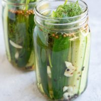 Two jars of pickles, ready to be refrigerated.