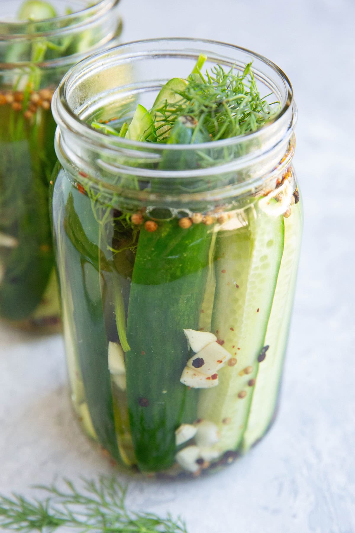 Two large jars of dill pickle spears.