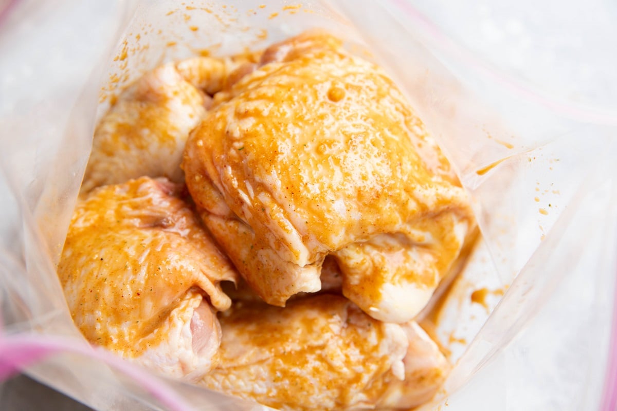 Chicken thighs in a zip lock bag in marinade.