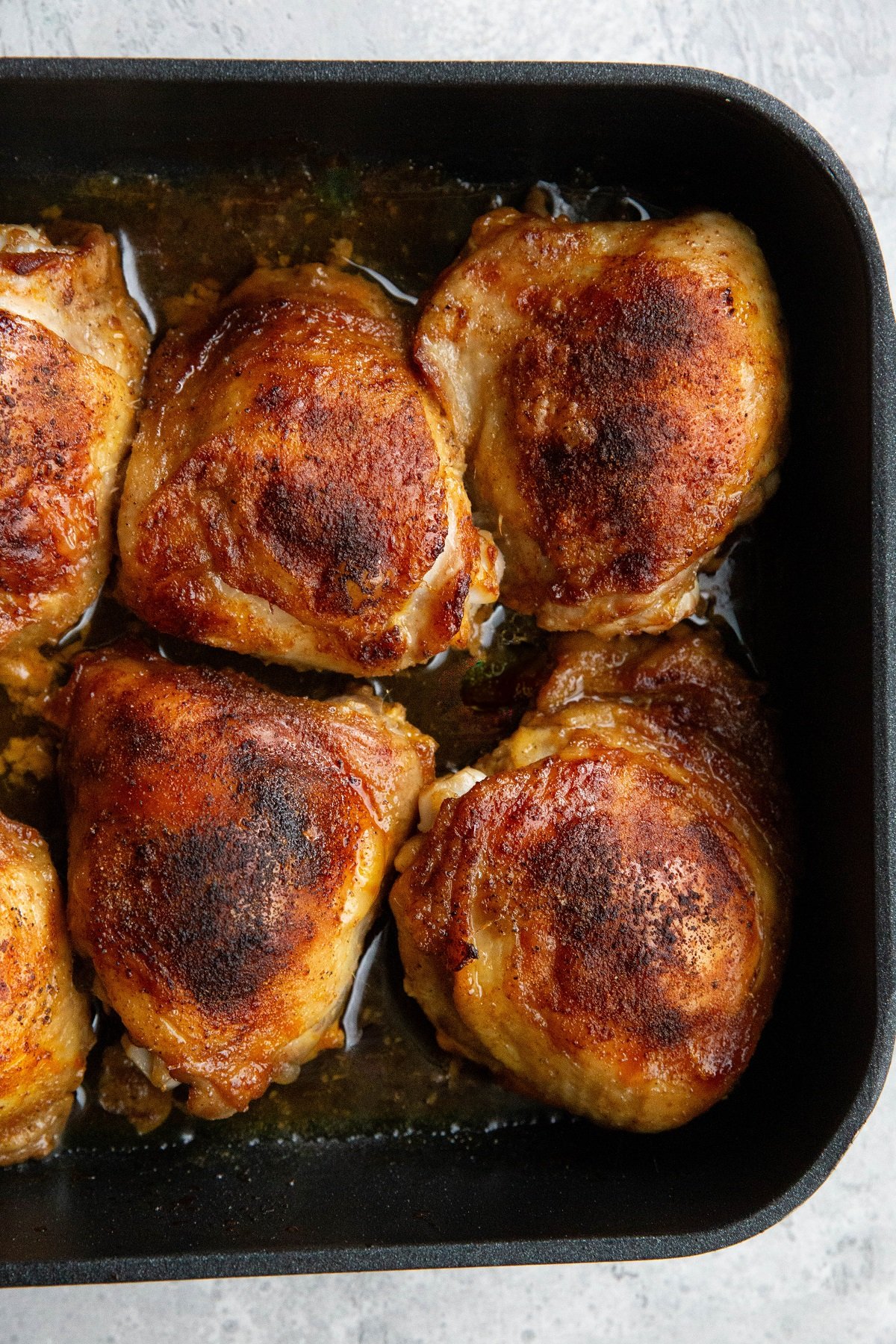 Baking dish with baked chicken inside, ready to eat.
