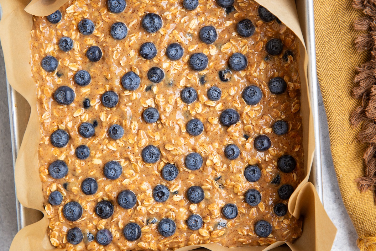 Blueberry mixture in a baking pan lined with parchment paper.