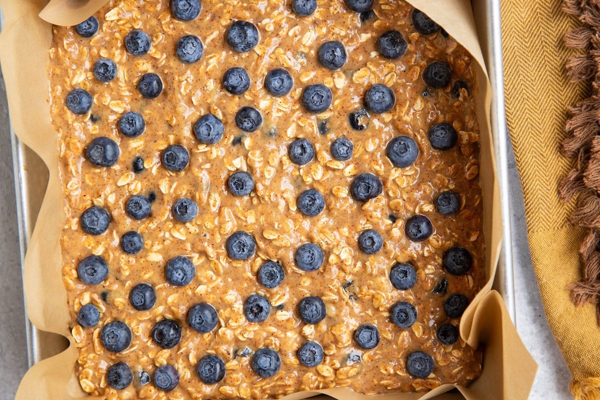 Blueberry mixture in a baking pan lined with parchment paper.