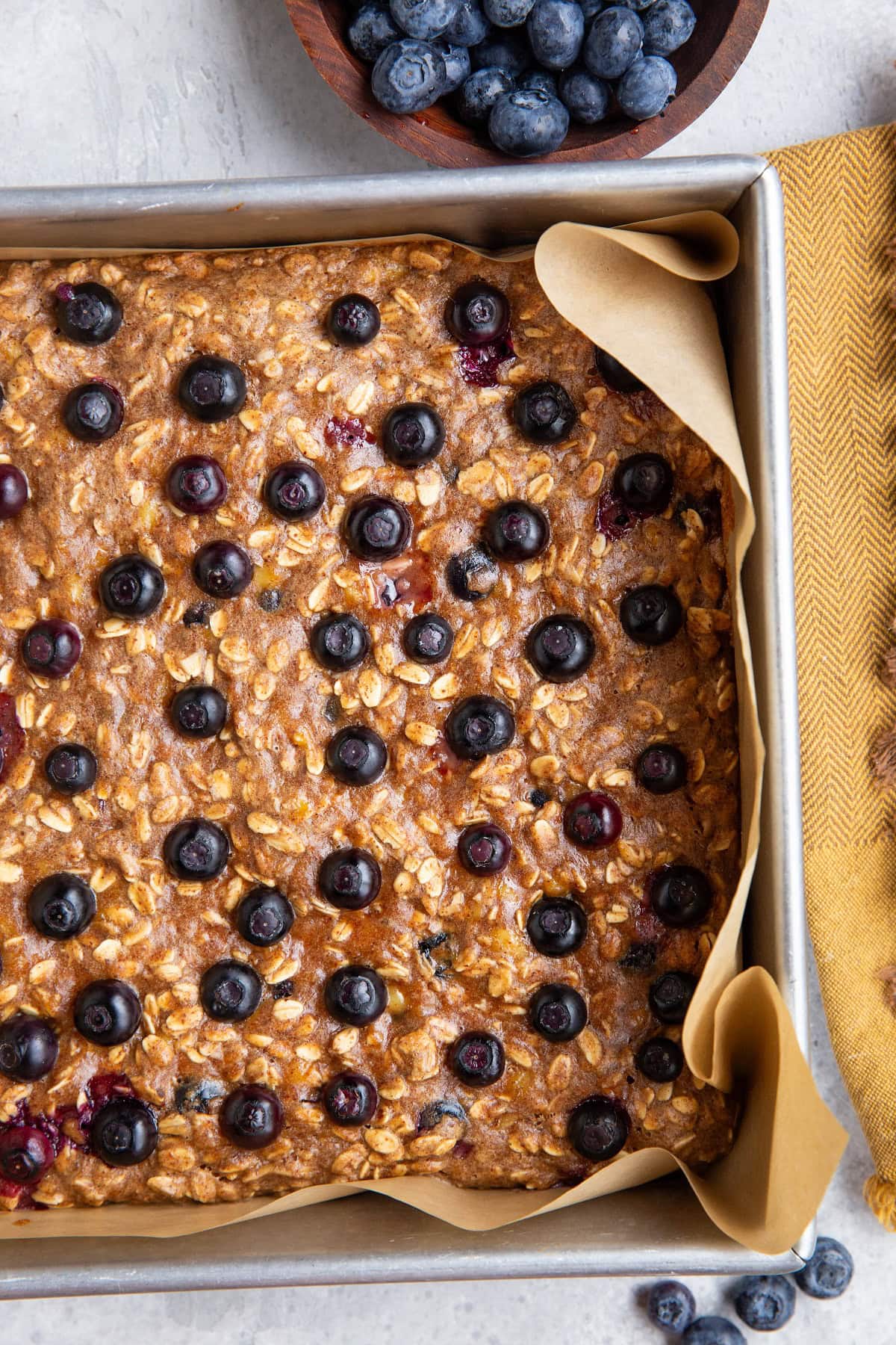 Baking pan with freshly baked blueberry oatmeal bars fresh out of the oven.