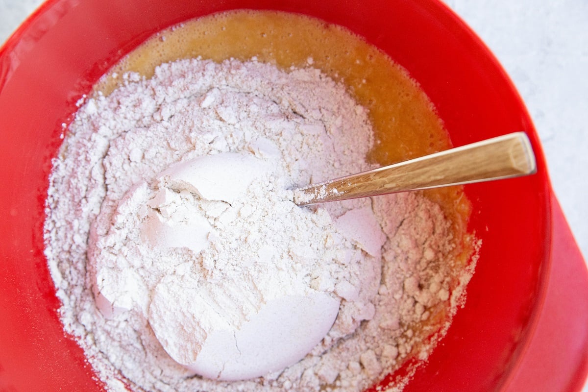 Oat flour in a mixing bowl on top of wet ingredients.