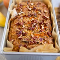 Morning glory quick bread in a loaf pan, fresh out of the oven.