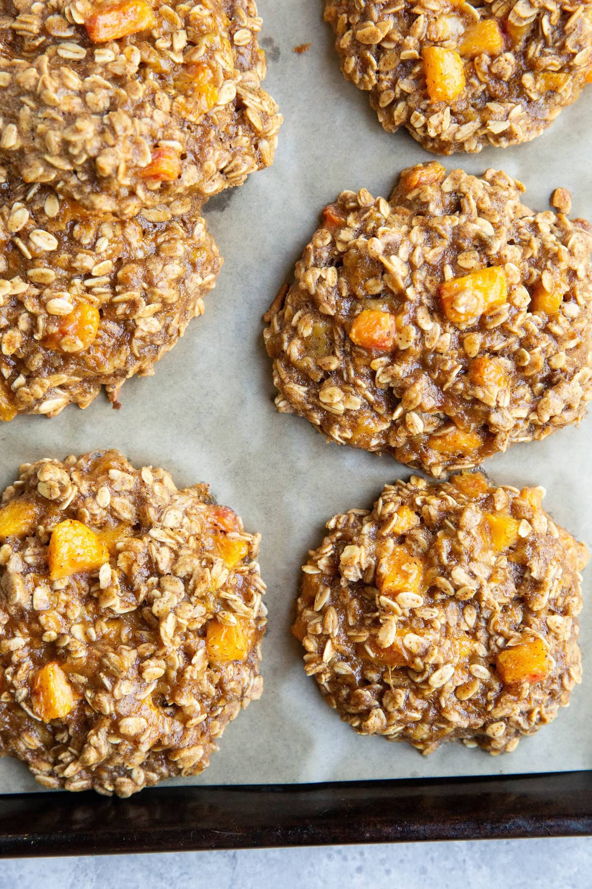 Cookie sheet with fresh peach oatmeal cookies fresh out of the oven.