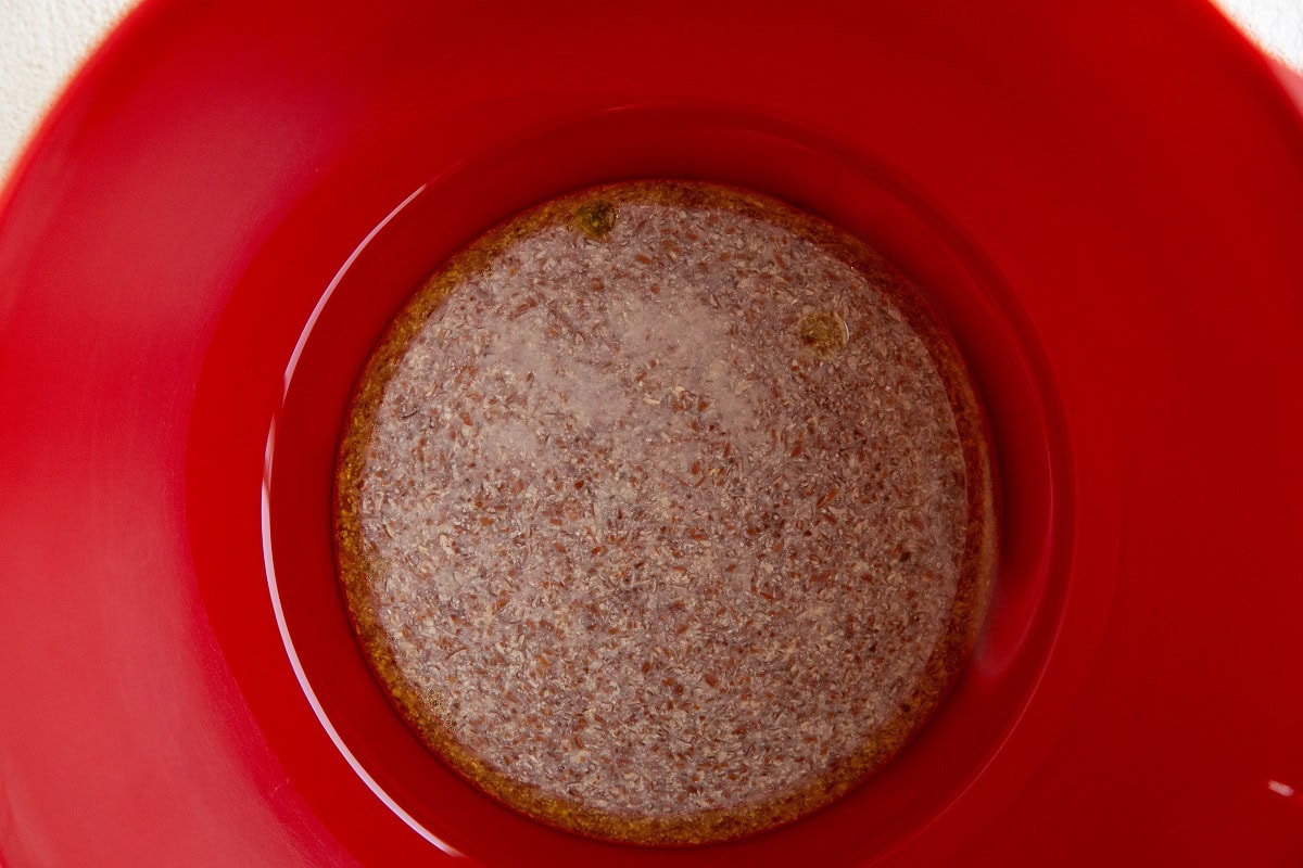 Flax eggs, oil, and pure maple syrup in a mixing bowl.