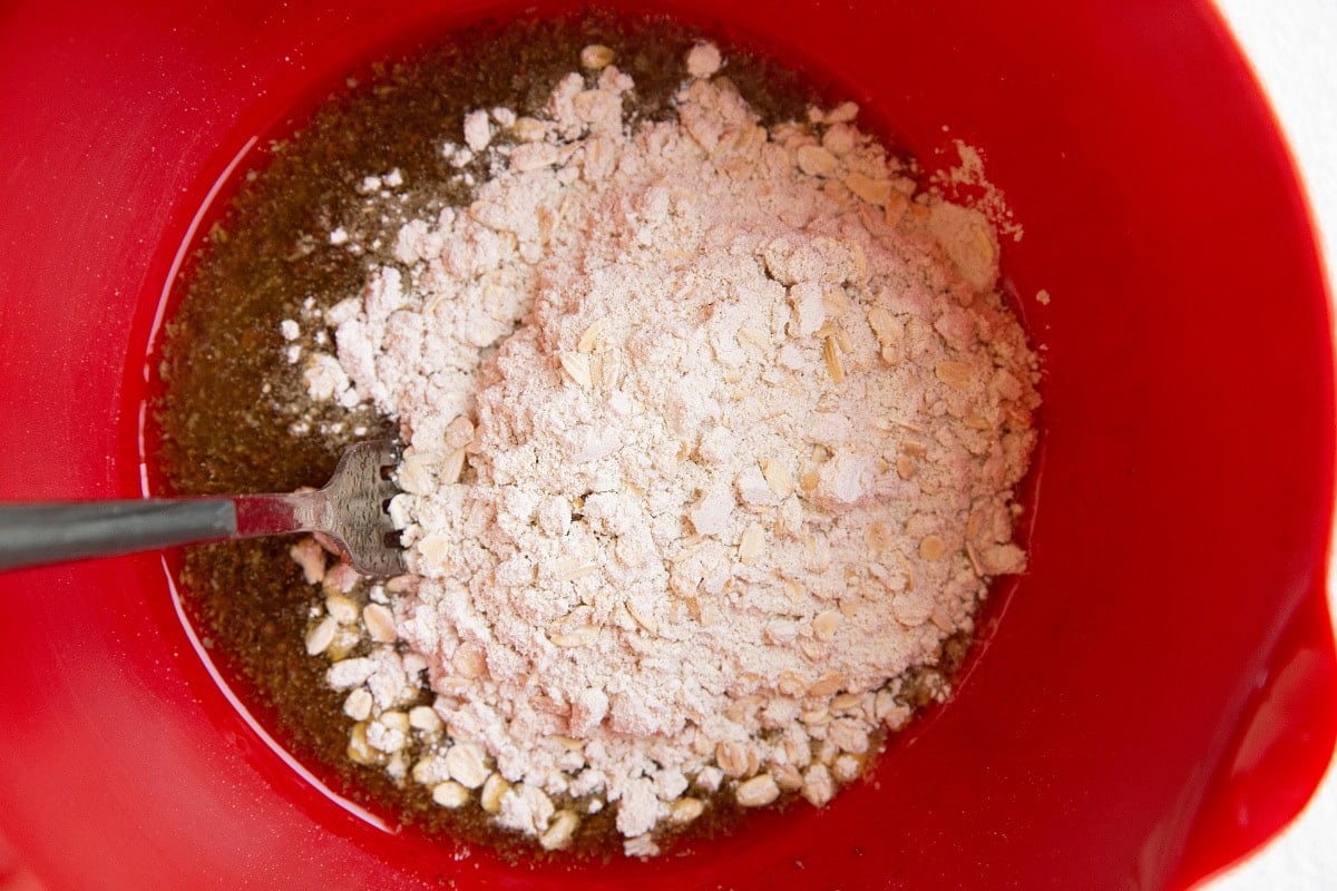 Dry ingredients on top of wet ingredients in a mixing bowl.