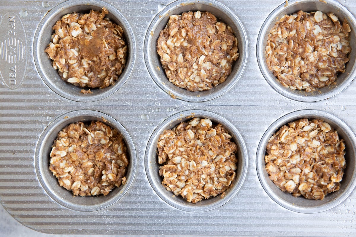 Oatmeal mixture in a muffin tray.