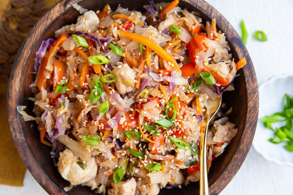 Wooden bowl of teriyaki chicken and vegetables.