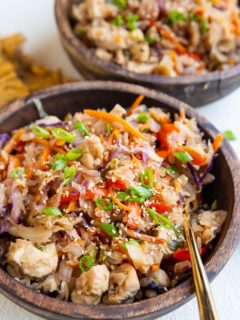 Two wood bowls of teriyaki chicken and veggies.