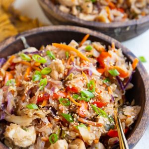 Two wood bowls of teriyaki chicken and veggies.