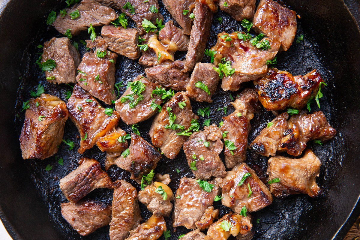 Finished steak bites in a cast iron skillet