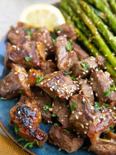 Blue plate of teriyaki steak bites.