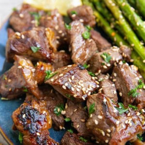 Blue plate of teriyaki steak bites.