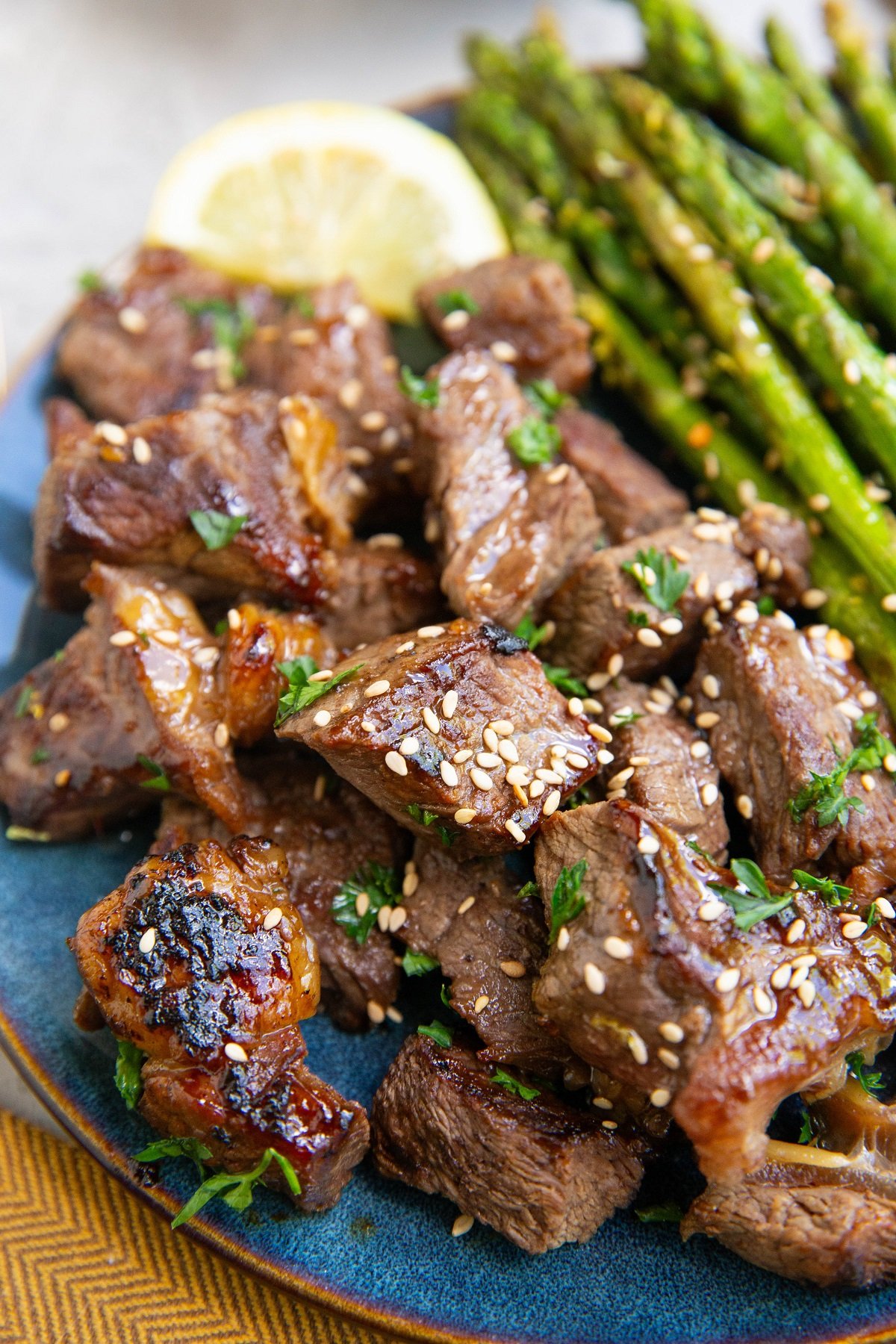 Blue plate of teriyaki steak bites.