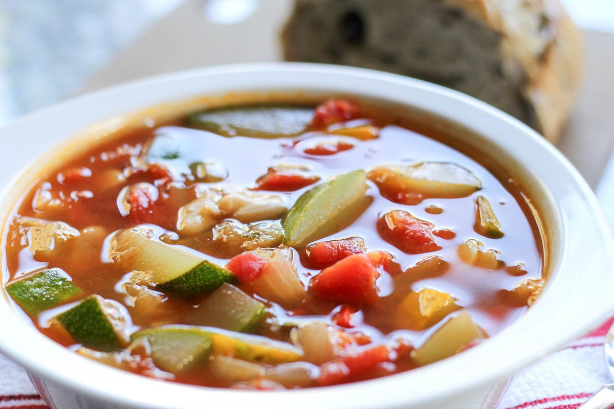 White bowl of summer squash soup.